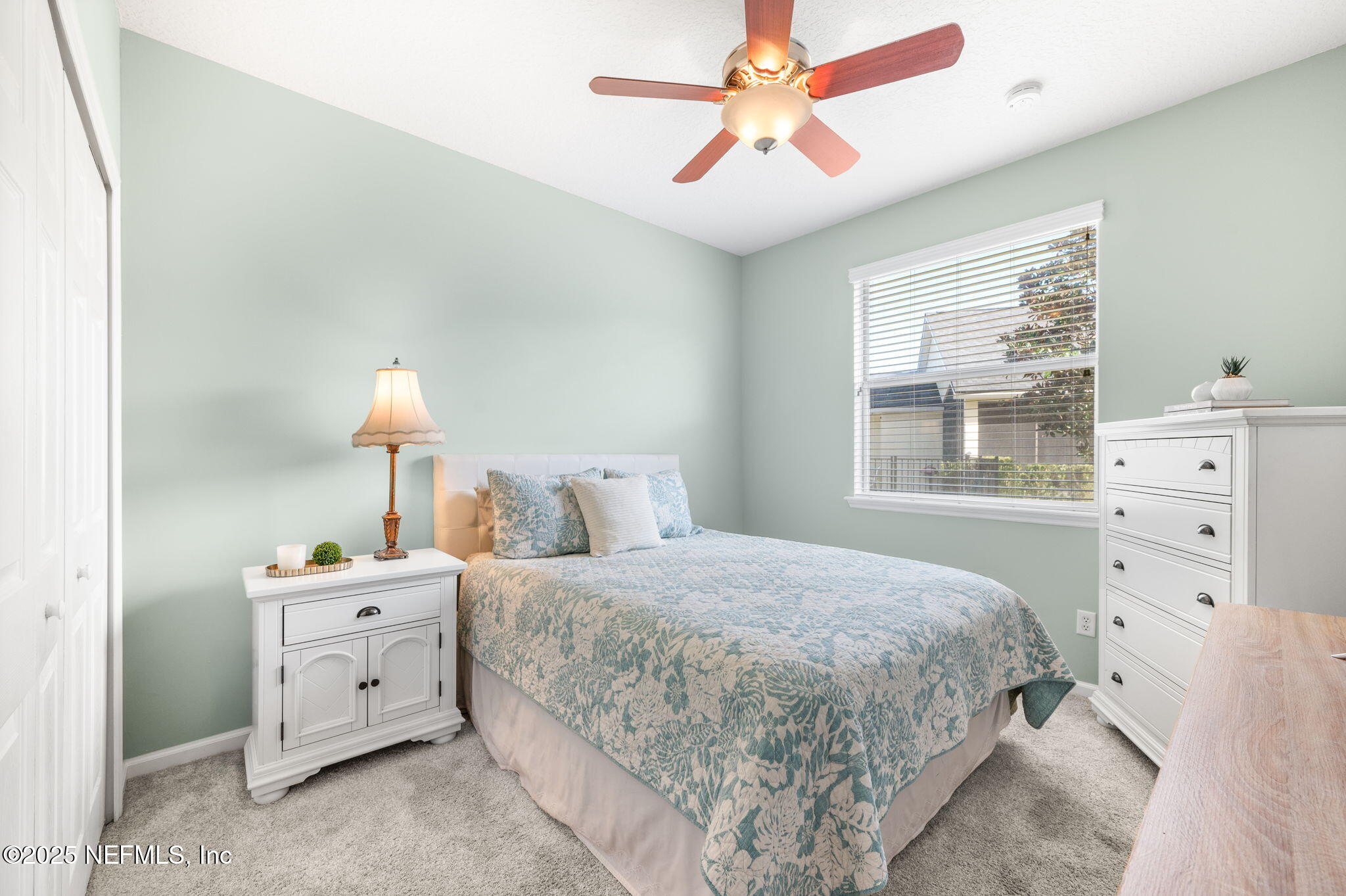 697 Copperhead Circle St. Augustine, FL 32092 - Photo 16 of 26 a bedroom with a bed and a chandelier