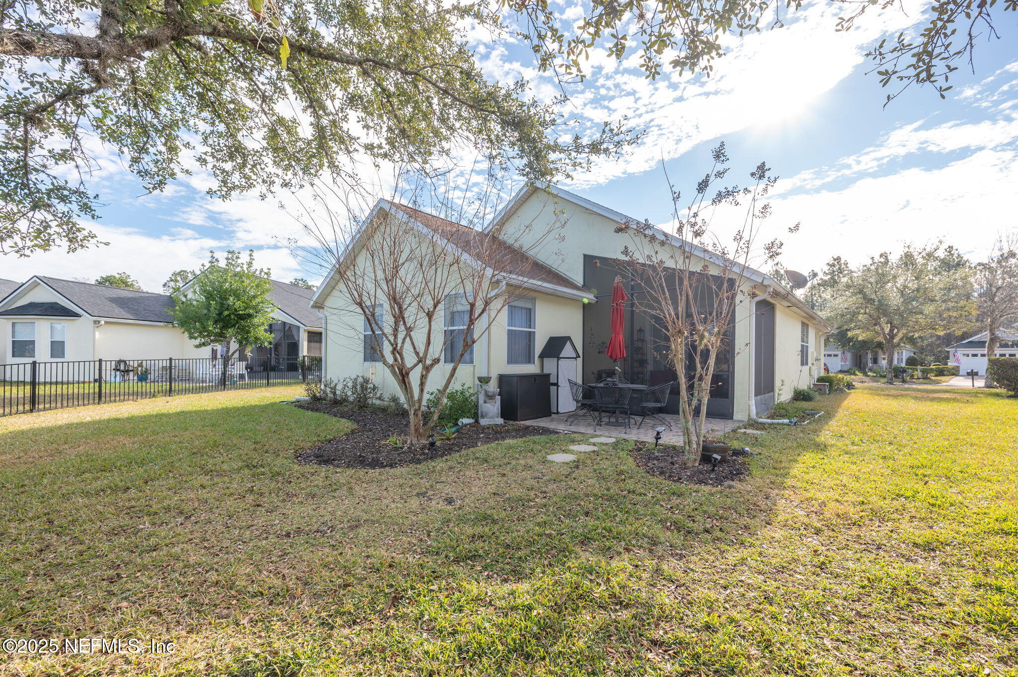697 Copperhead Circle St. Augustine, FL 32092 - Photo 23 of 26 a view of a house with a yard and large tree