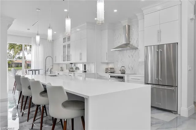 a kitchen with stainless steel appliances a sink stove and refrigerator