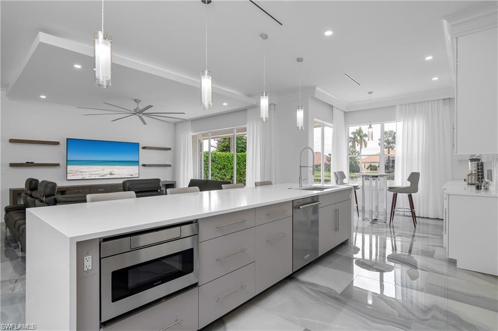 8967 Lely Island Circle Naples, FL 34113 - Photo 18 of 46 a kitchen with a sink cabinets and window