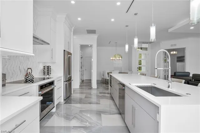 a large kitchen with a sink and cabinets