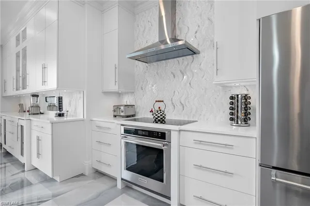 a kitchen with stainless steel appliances white cabinets and white appliances