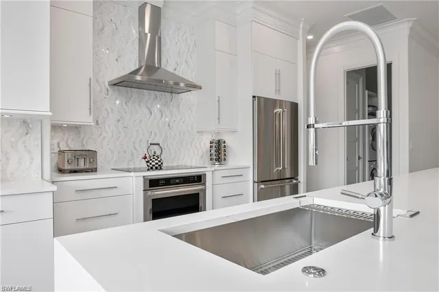 a kitchen with a stove a refrigerator and cabinets