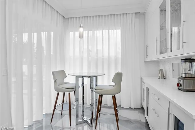 a view of a dining room with furniture and a window