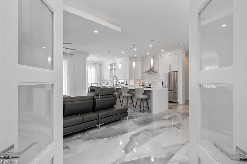 8967 Lely Island Circle Naples, FL 34113 - Photo 26 of 46 a living room with furniture and a view of kitchen