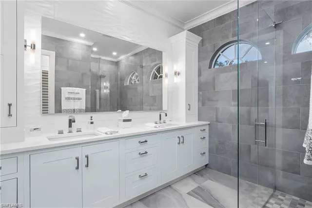 a bathroom with a double vanity sink mirror and double