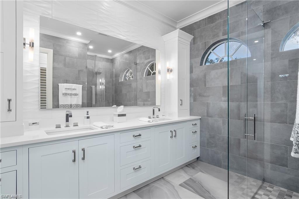 8967 Lely Island Circle Naples, FL 34113 - Photo 34 of 46 a bathroom with a double vanity sink mirror and double