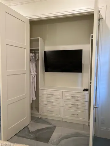 a bathroom with a shower and an empty walk in closet
