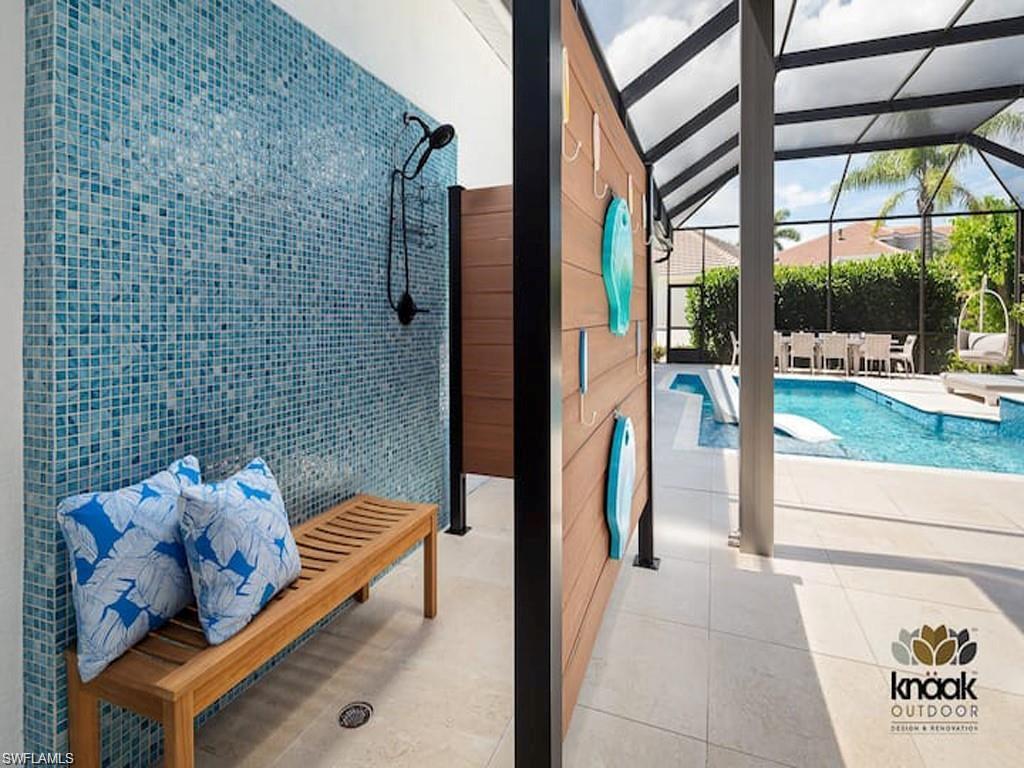 8967 Lely Island Circle Naples, FL 34113 - Photo 5 of 46 a view of living room kitchen and entryway