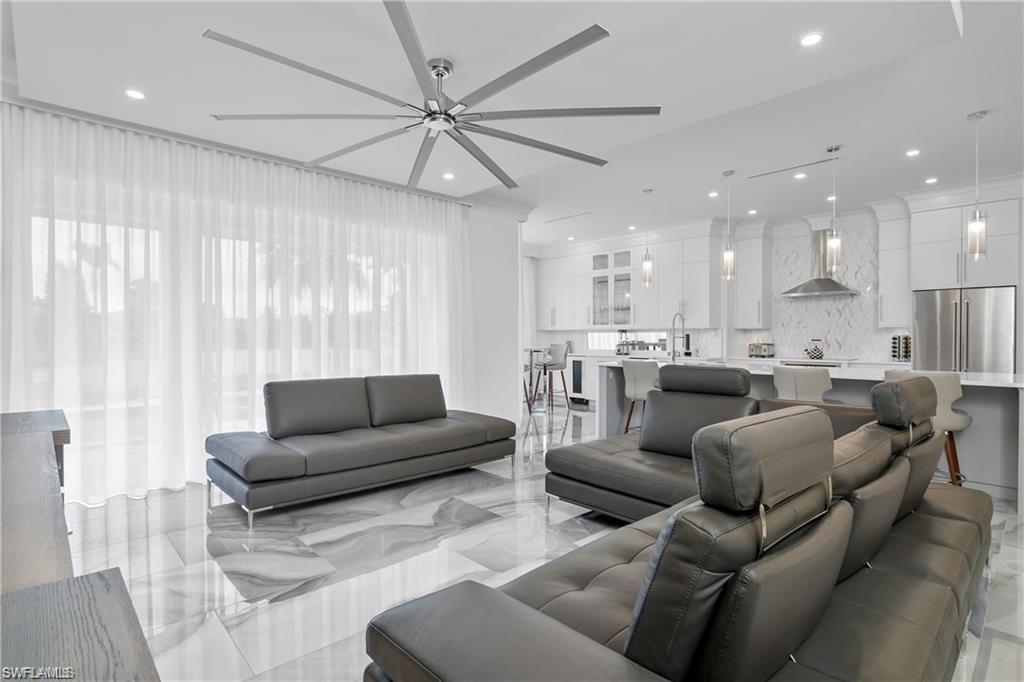 8967 Lely Island Circle Naples, FL 34113 - Photo 10 of 46 a living room with furniture and a large window