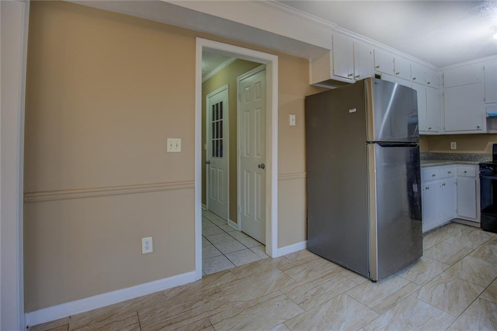 1457 Cherry Hill Road Southwest Conyers, GA 30094 - Photo 13 of 31 an empty room with wooden floor and a window