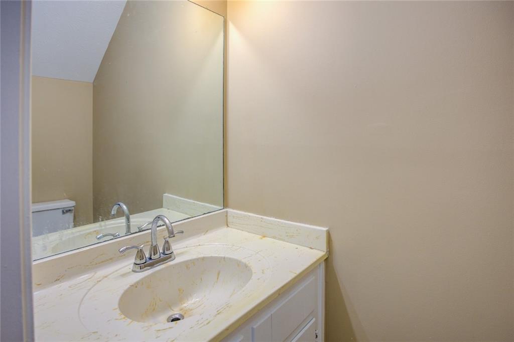 1457 Cherry Hill Road Southwest Conyers, GA 30094 - Photo 17 of 31 a bathroom with a sink and a mirror
