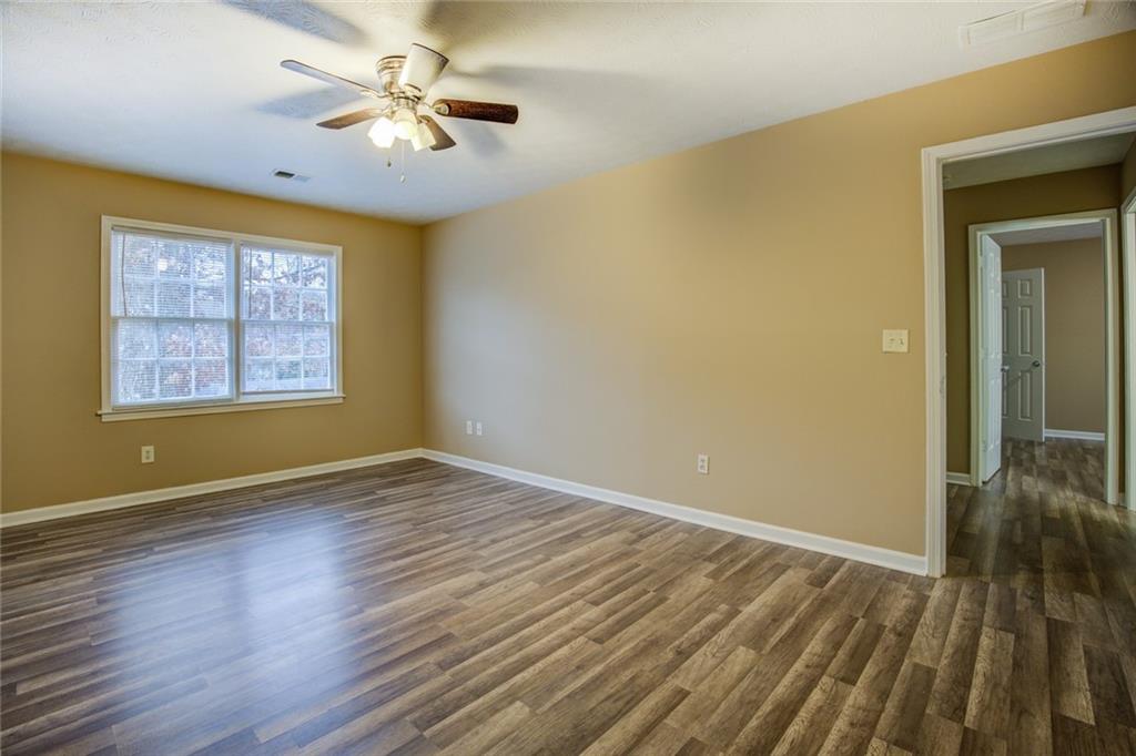 1457 Cherry Hill Road Southwest Conyers, GA 30094 - Photo 20 of 31 wooden floor in an empty room with a window
