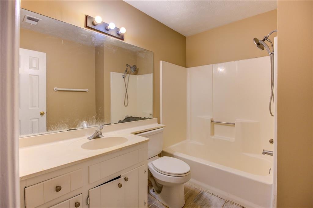 1457 Cherry Hill Road Southwest Conyers, GA 30094 - Photo 22 of 31 a bathroom with a sink a toilet and shower