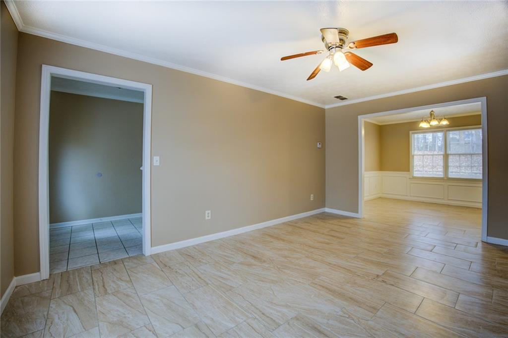 1457 Cherry Hill Road Southwest Conyers, GA 30094 - Photo 5 of 31 wooden floor in an empty room with a window