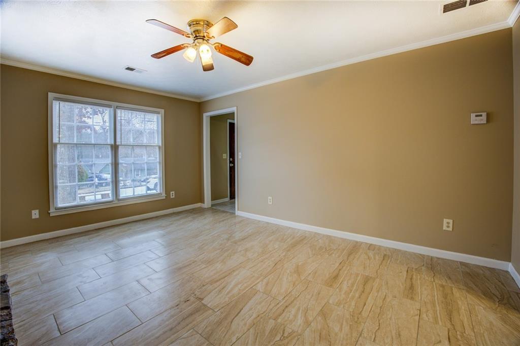 1457 Cherry Hill Road Southwest Conyers, GA 30094 - Photo 7 of 31 a view of room with window and ceiling fan