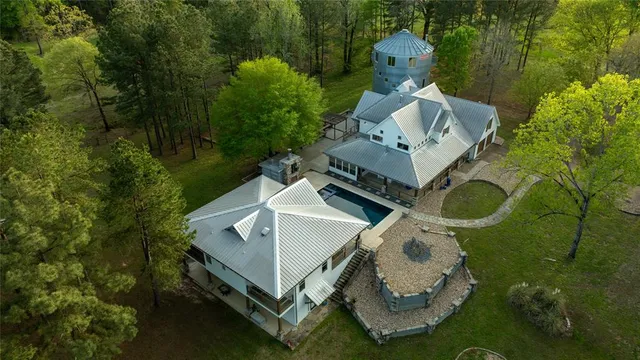 an aerial view of a house with a yard and balcony