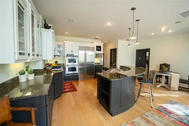 a kitchen with stainless steel appliances granite countertop a stove oven and a refrigerator