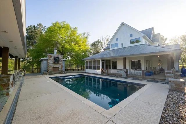 a front view of house with swimming pool and sitting area