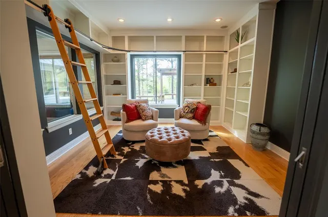 a living room with furniture and a floor to ceiling window
