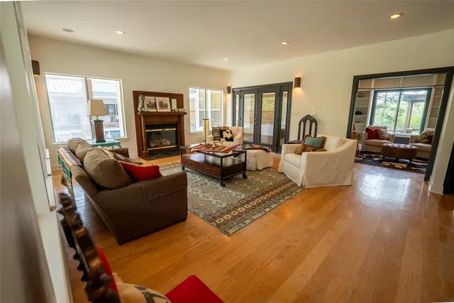 a living room with furniture fireplace and a large window
