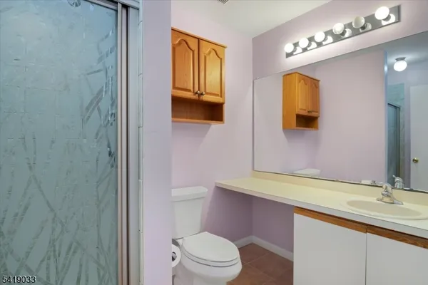 a view of an empty room with closet and a window