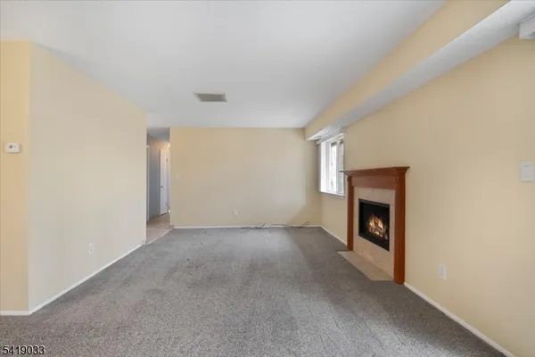 a view of empty room with a fireplace