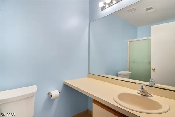 a view of a white building among the street and a building