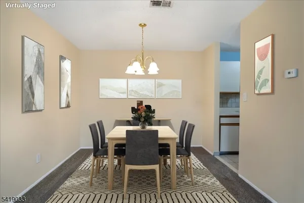 a view of a dining room with furniture and window