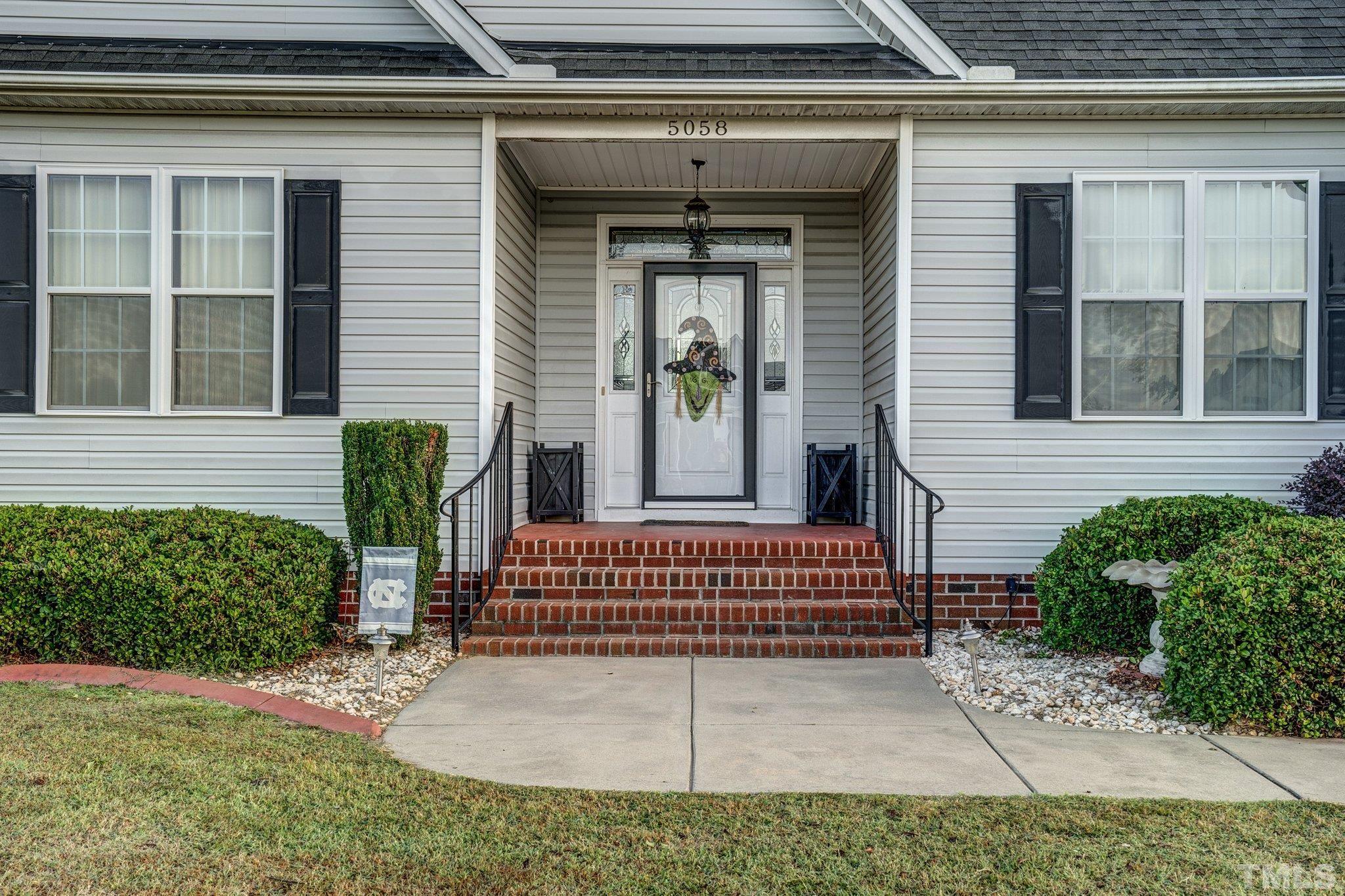 5058 Colorado Road Bailey, NC 27807 - Photo 2 of 27 a view of a house with a small yard and plants