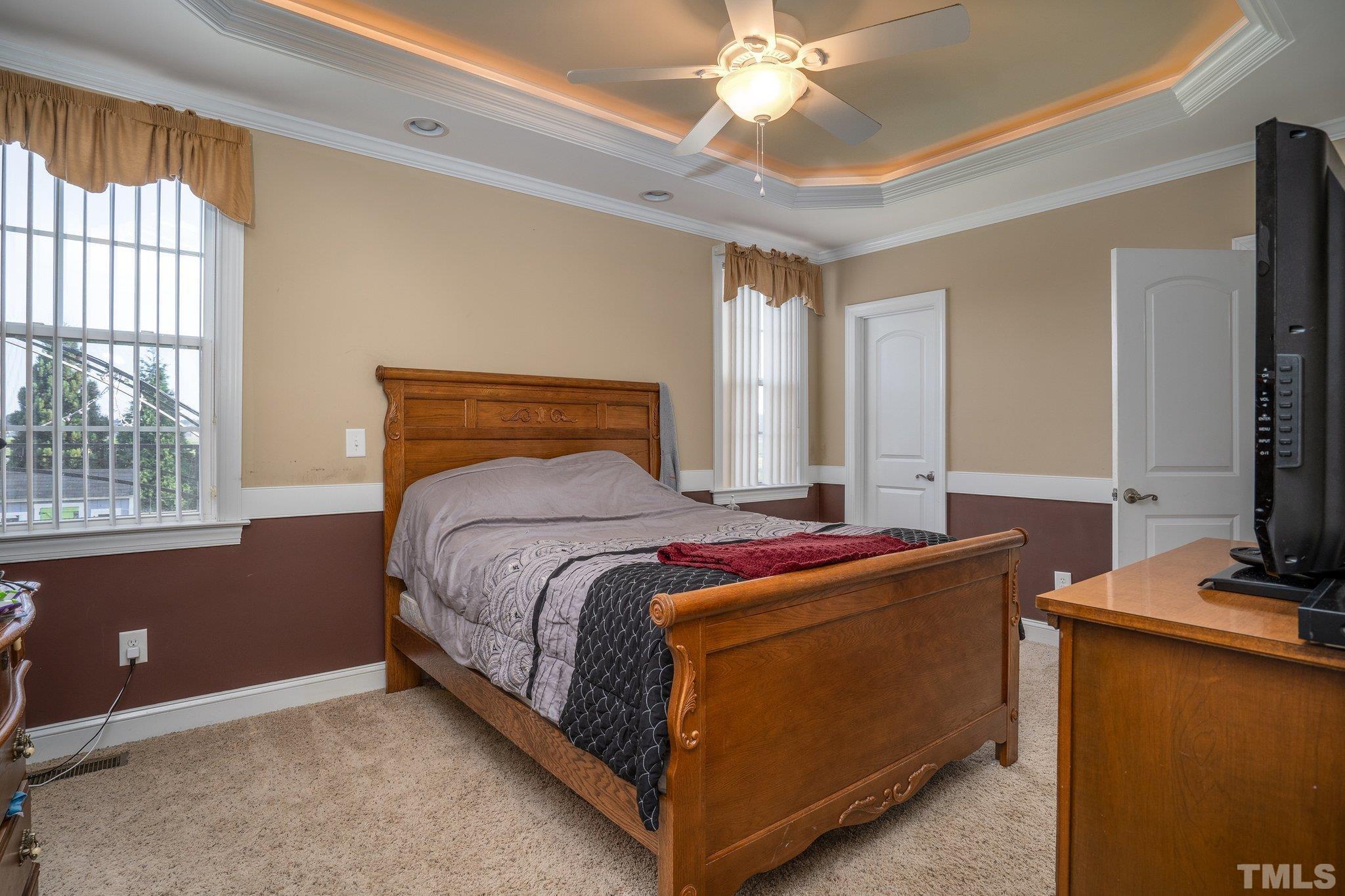 5058 Colorado Road Bailey, NC 27807 - Photo 13 of 27 a bedroom with a bed and a chandelier
