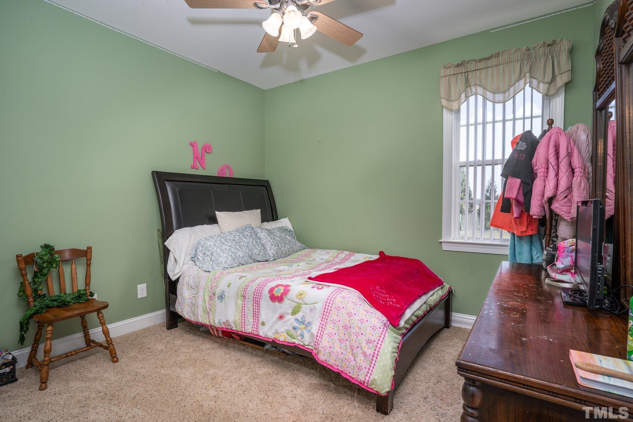 5058 Colorado Road Bailey, NC 27807 - Photo 16 of 27 a bedroom with a bed and a chandelier