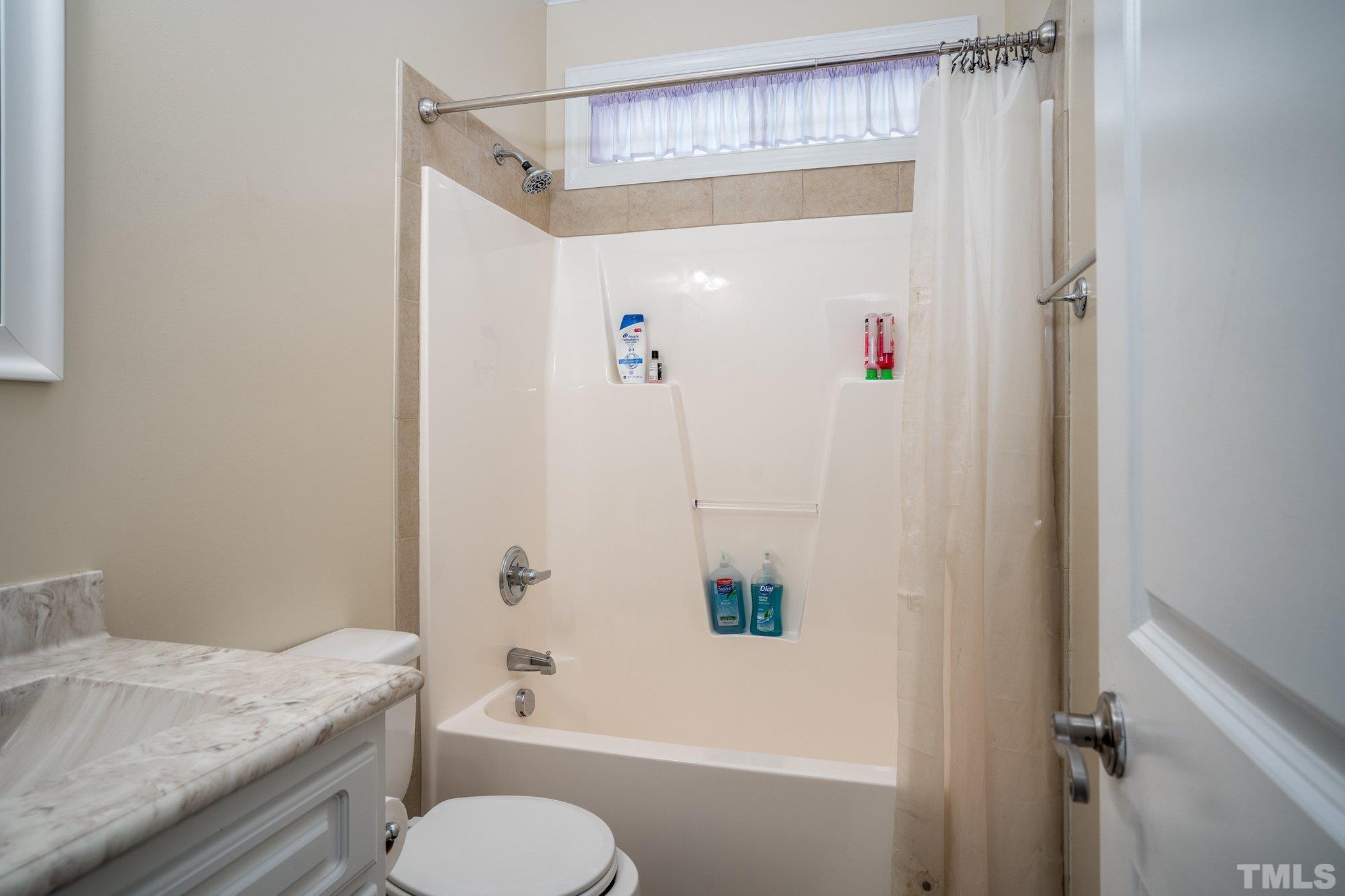 5058 Colorado Road Bailey, NC 27807 - Photo 17 of 27 a bathroom with a granite countertop sink toilet and shower