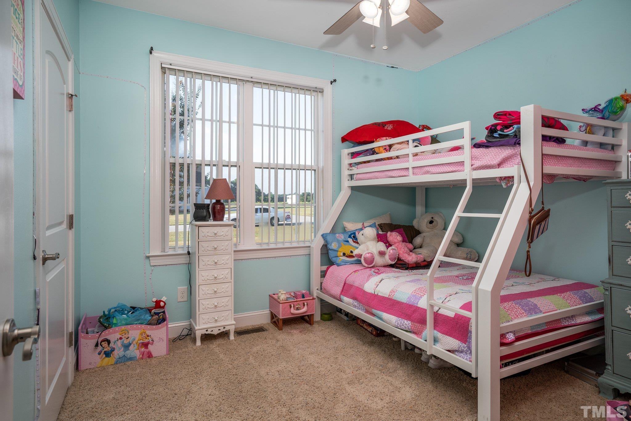 5058 Colorado Road Bailey, NC 27807 - Photo 19 of 27 a bedroom with a bed and a chandelier