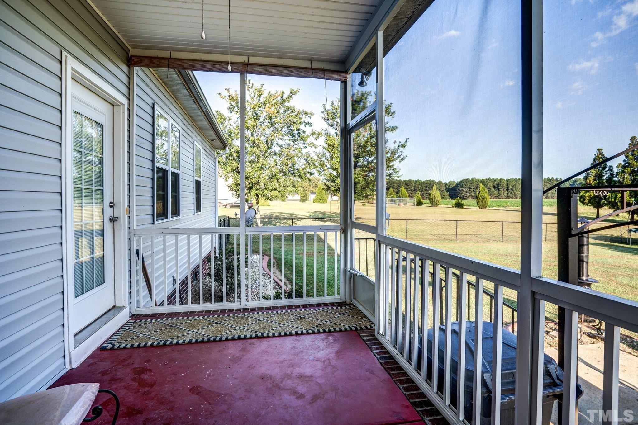 5058 Colorado Road Bailey, NC 27807 - Photo 25 of 27 a view of a porch with a floor to ceiling window and wooden floor