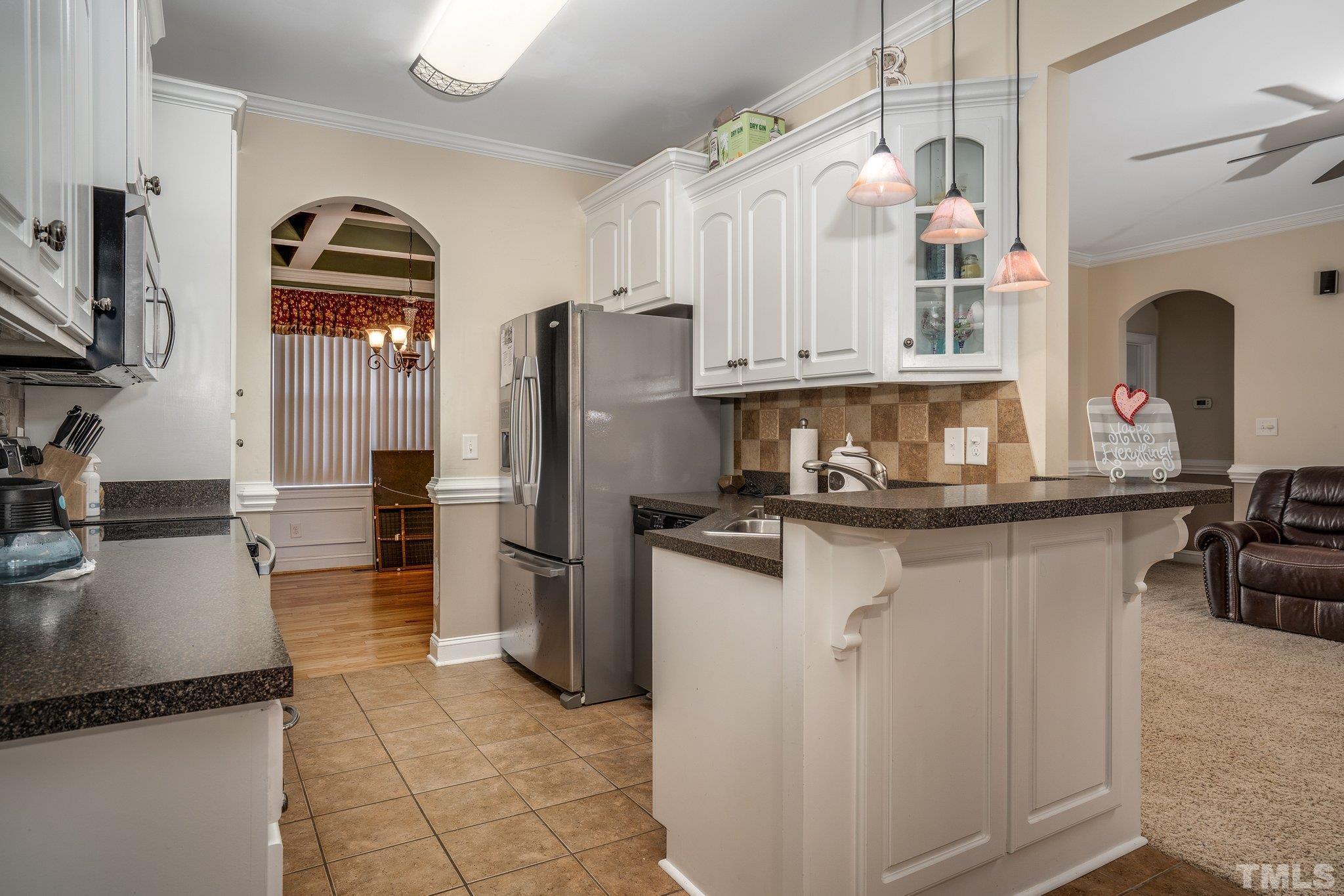 5058 Colorado Road Bailey, NC 27807 - Photo 8 of 27 a kitchen with stainless steel appliances granite countertop a refrigerator a stove and a sink
