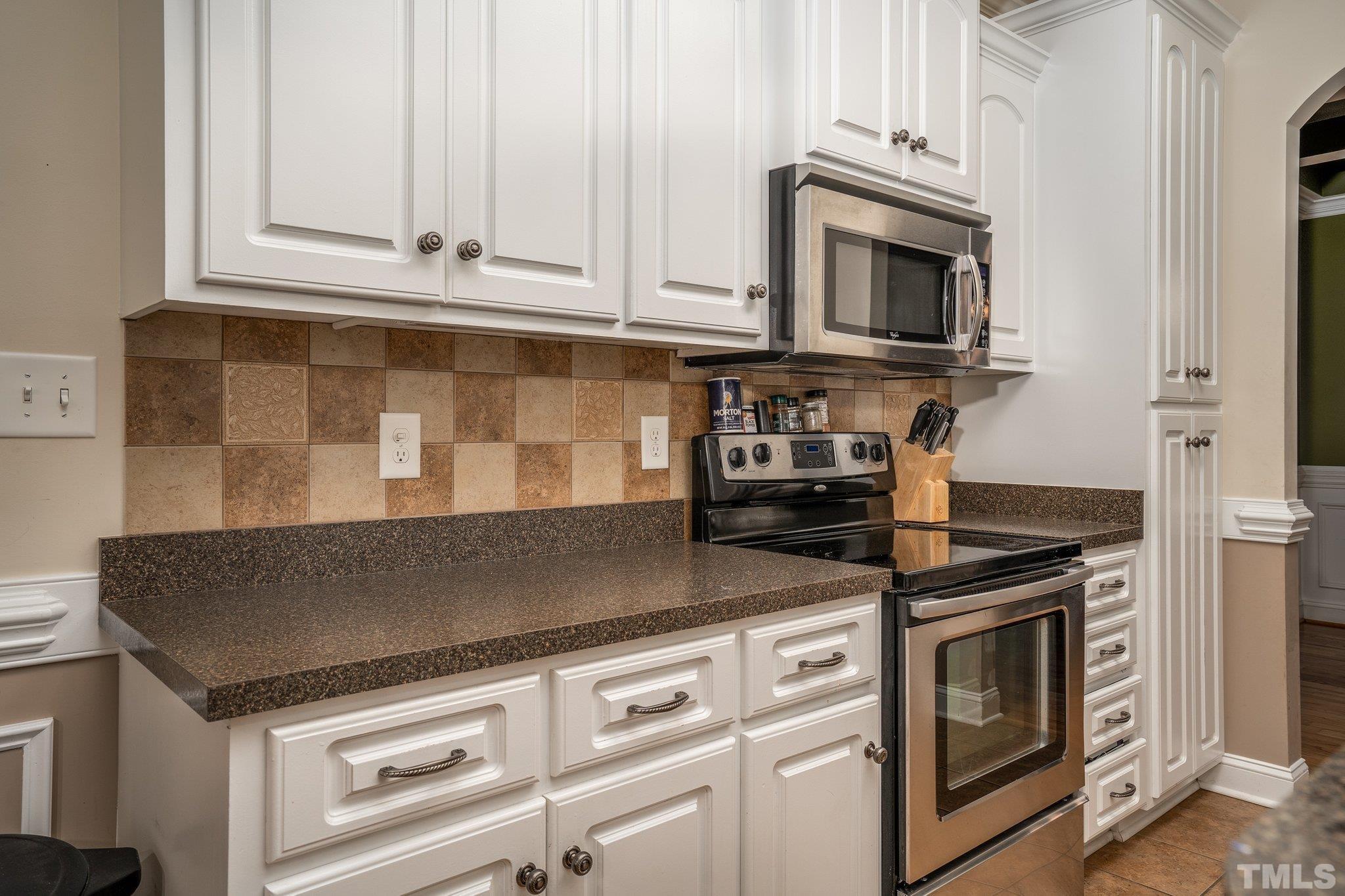 5058 Colorado Road Bailey, NC 27807 - Photo 10 of 27 a kitchen with granite countertop white cabinets and stainless steel appliances