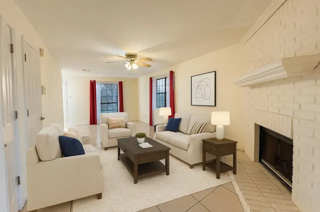 a living room with furniture and a fireplace