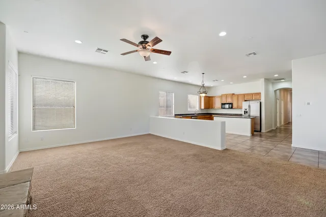a view of kitchen with refrigerator and window