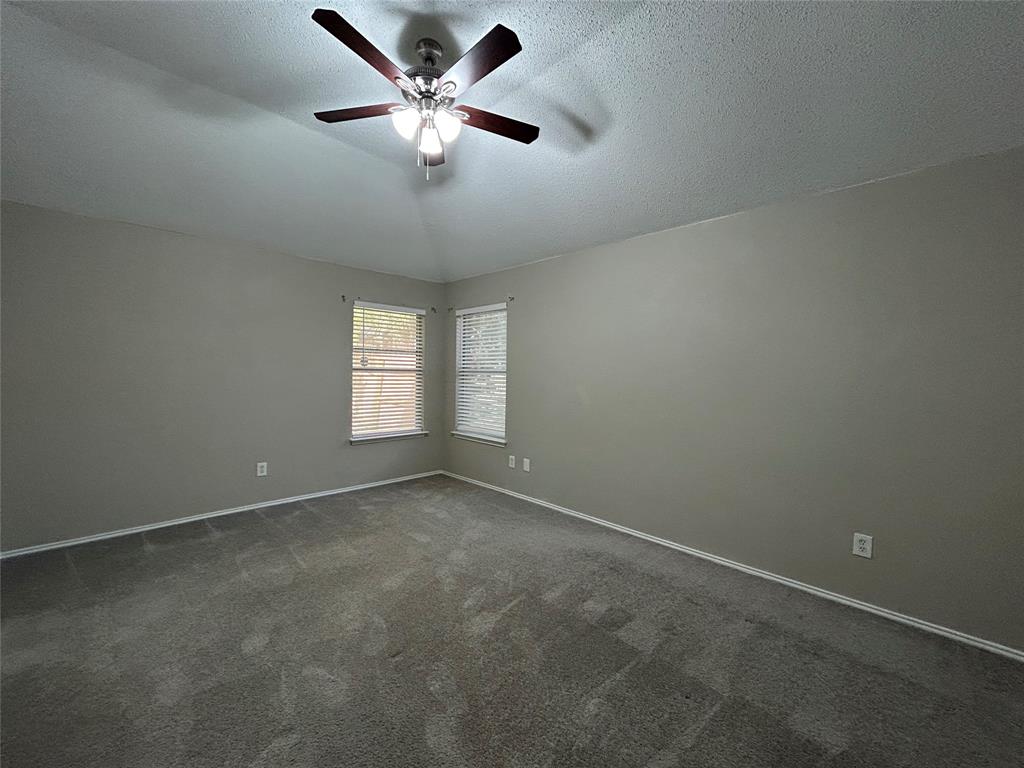 2816 Beaty Court Fort Worth, TX 76112 - Photo 11 of 24 an empty room with a window and a fan