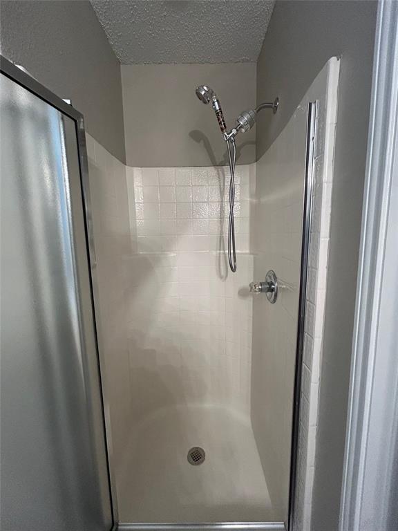 2816 Beaty Court Fort Worth, TX 76112 - Photo 13 of 24 a bathroom with a glass shower door and sink