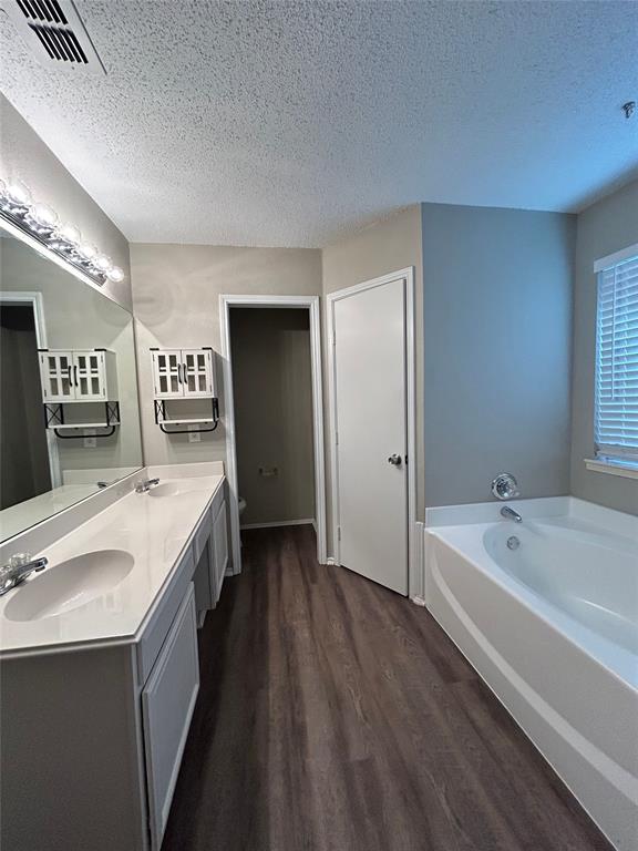 2816 Beaty Court Fort Worth, TX 76112 - Photo 14 of 24 a spacious bathroom with a double vanity sink a mirror and a bathtub