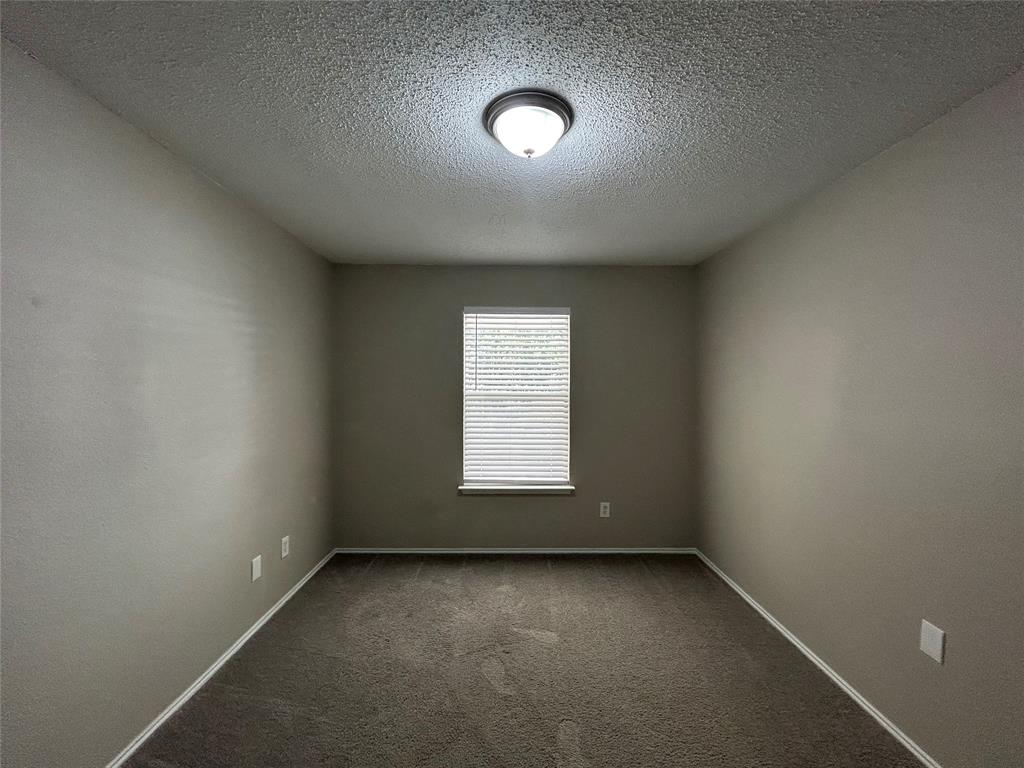 2816 Beaty Court Fort Worth, TX 76112 - Photo 16 of 24 an empty room with a window and pillar in it
