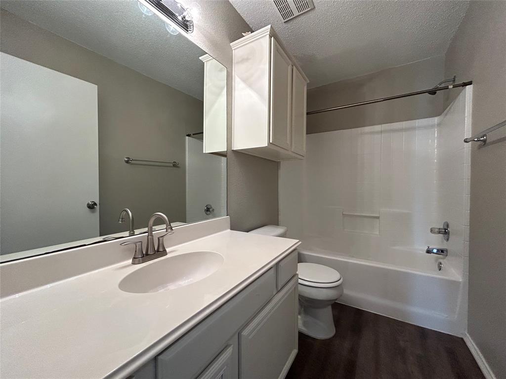 2816 Beaty Court Fort Worth, TX 76112 - Photo 20 of 24 a bathroom with a sink toilet vanity and shower