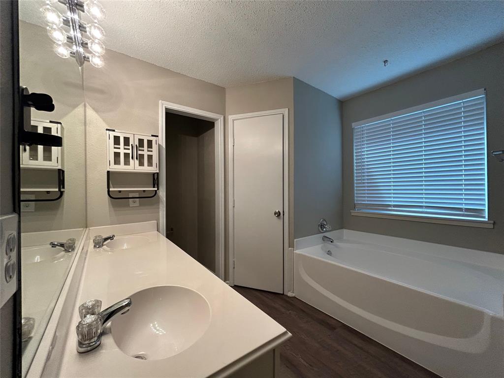 2816 Beaty Court Fort Worth, TX 76112 - Photo 21 of 24 a bathroom with a tub sink and mirror