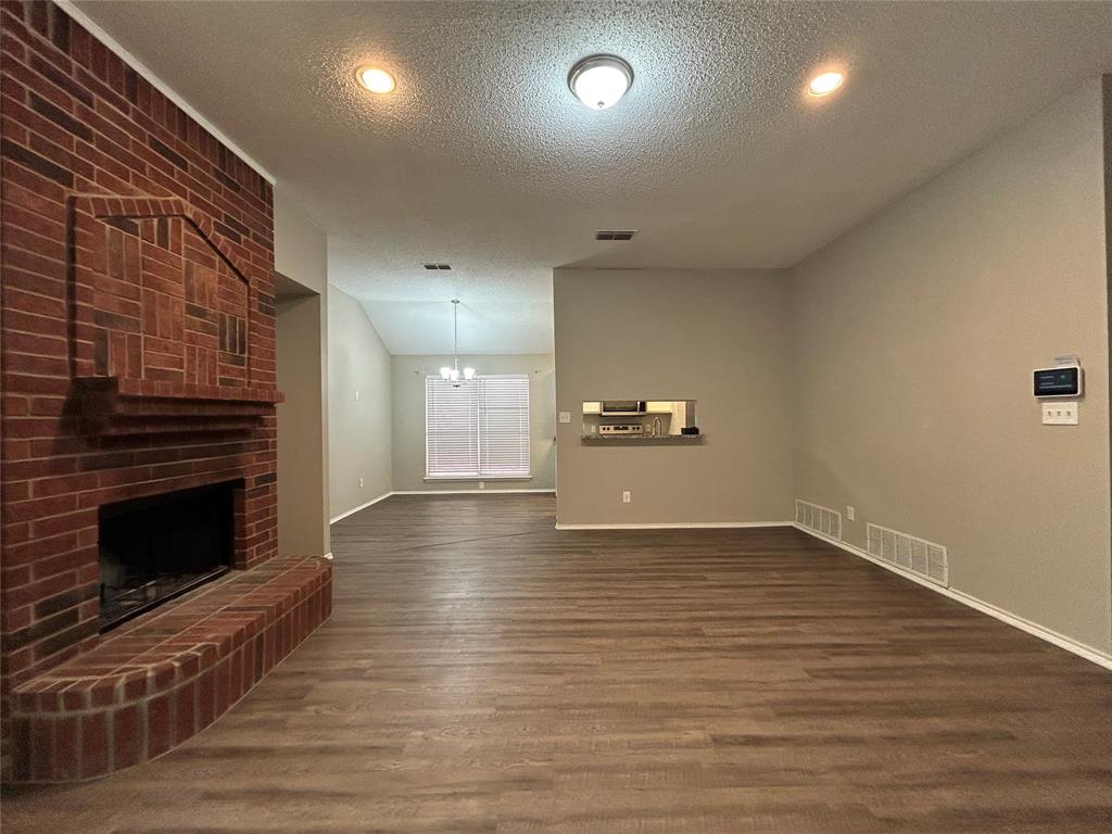 2816 Beaty Court Fort Worth, TX 76112 - Photo 3 of 24 a view of empty room with wooden floor and fireplace