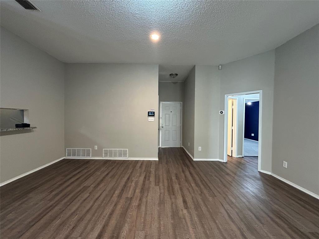 2816 Beaty Court Fort Worth, TX 76112 - Photo 4 of 24 a view of an empty room and wooden floor