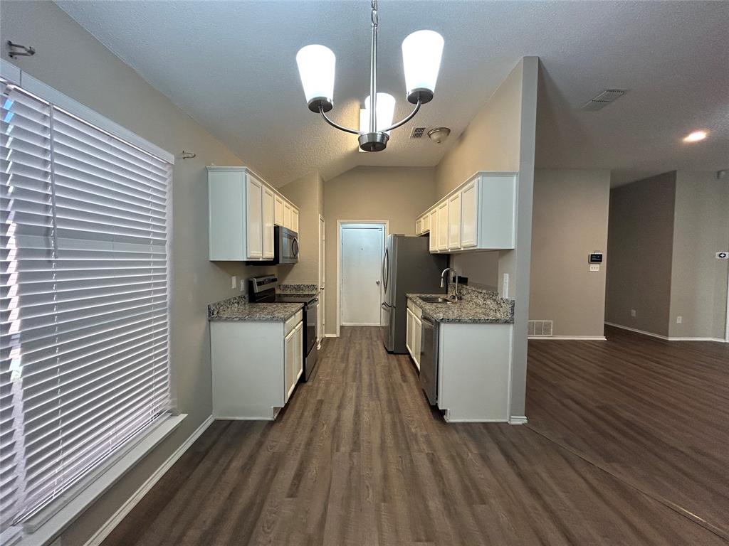 2816 Beaty Court Fort Worth, TX 76112 - Photo 8 of 24 a view of kitchen and dining room with wooden floor