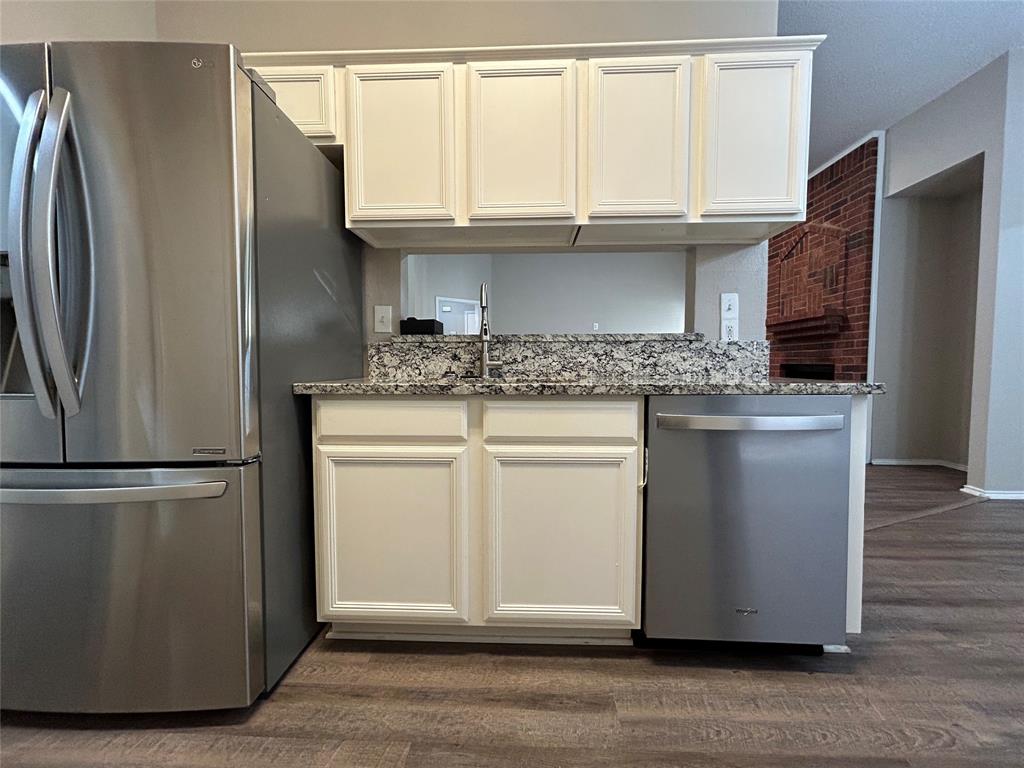 2816 Beaty Court Fort Worth, TX 76112 - Photo 9 of 24 a kitchen with stainless steel appliances granite countertop a refrigerator a sink and a stove