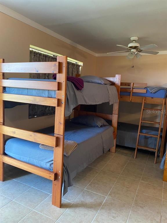 1587 Wayman Road Moore Haven, FL 33471 - Photo 5 of 7 a bedroom with a bunk bed and a desk